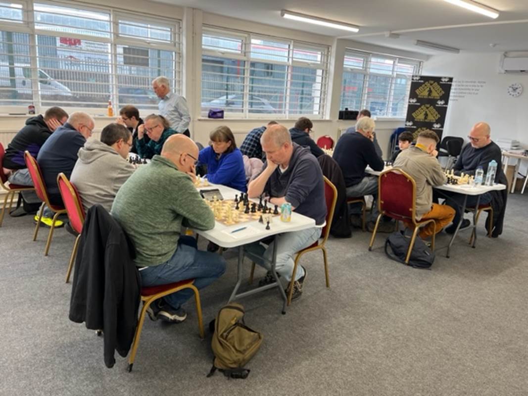 A group of people playing chess

Description automatically generated